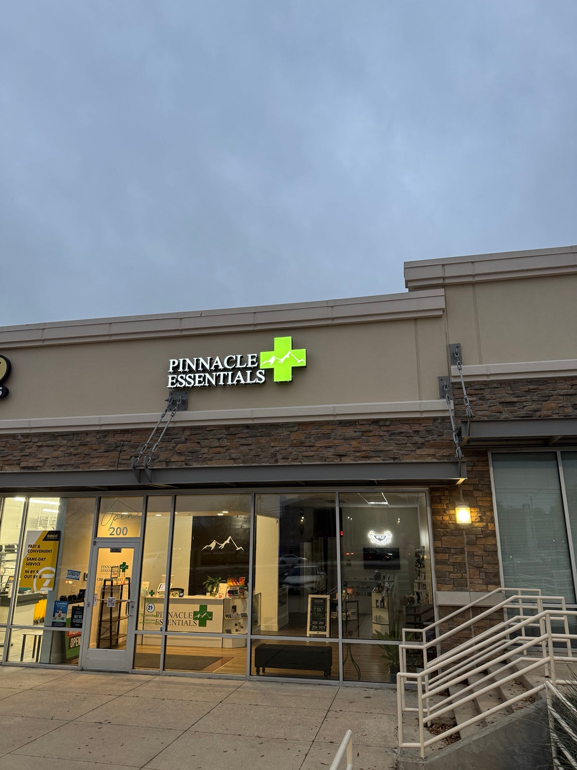 Pinnacle Essentials storefront entrance in daylight
