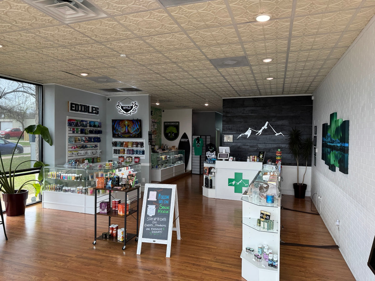 Pinnacle Essentials store interior with product displays and mountain logo